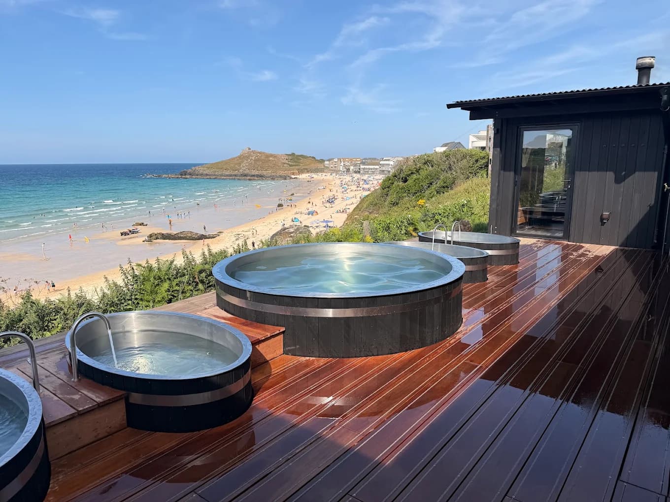 Bespoke round timber-clad cold plunges at Kiln Sauna, St Ives